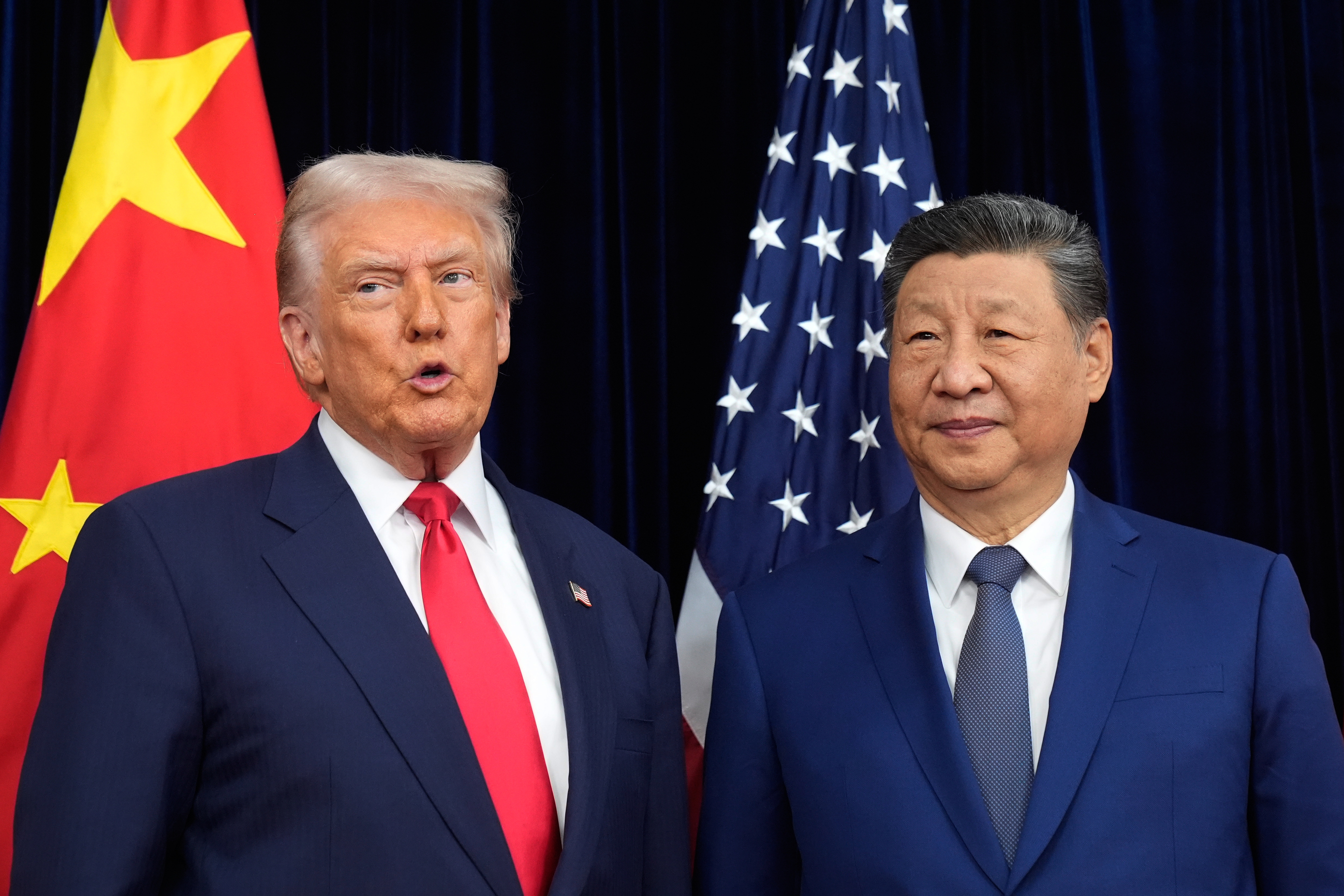 President Donald Trump, left, and Chinese President Xi Jinping pose together ahead of their summit talk at Gimhae International Airport in Busan, South Korea, on Thursday.